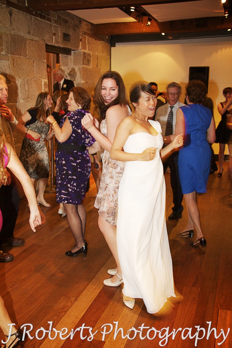 Bride grooving on dancefloor - wedding photography sydney
